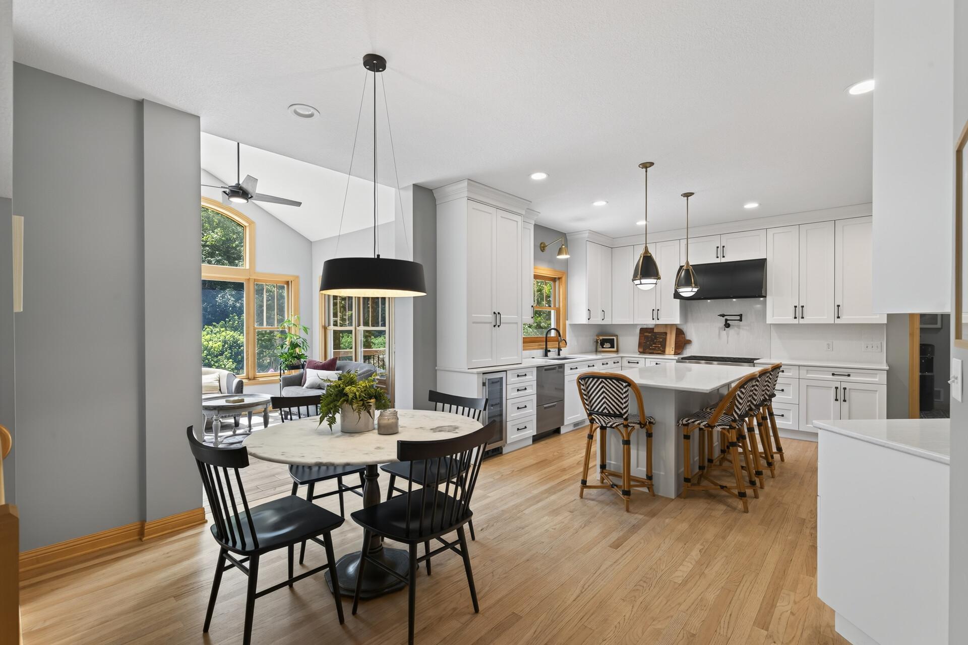 This stunning chef-designed custom kitchen is nothing short of extraordinary; a massive center island with breakfast bar, eat-in dining, and sunroom beyond create a space where cooking, gathering, and entertaining all happen effortlessly.