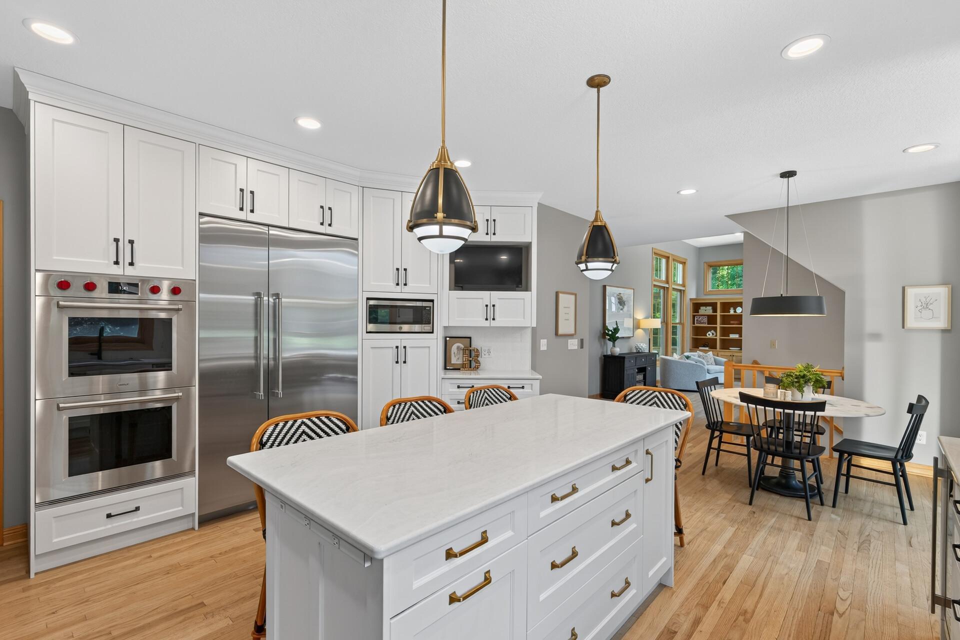 Custom designer light fixtures catch the eye while the gorgeous Cambria countertops steal the show; this center island view is a reminder that no detail was overlooked in this extraordinary kitchen.