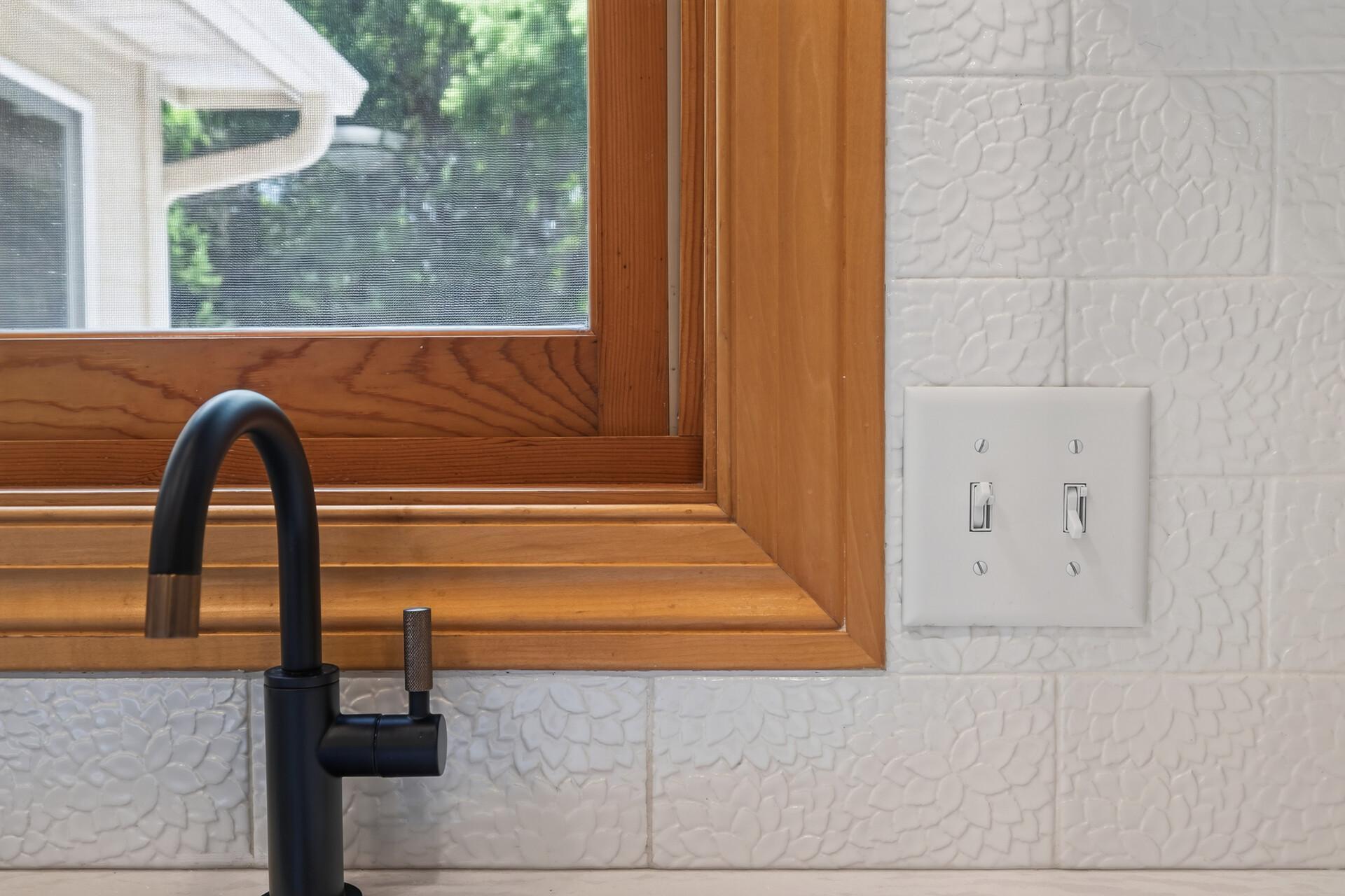This stunning handmade white tile backsplash is pure artistry; the kind of detail that elevates an already extraordinary kitchen into something truly one of a kind.