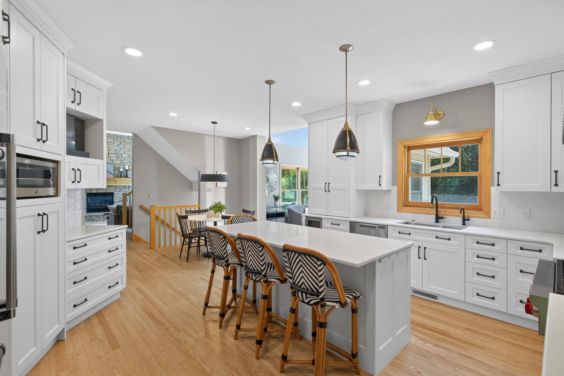 A massive center island, floor-to-ceiling enameled white cabinetry, and custom built-in storage throughout; this kitchen was designed by people who understand that great cooking starts with exceptional organization.