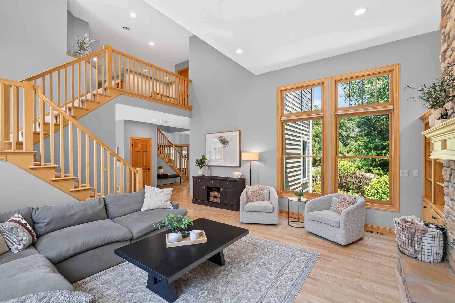 Soaring two-story ceilings create an incredible sense of grandeur in this spacious living room.