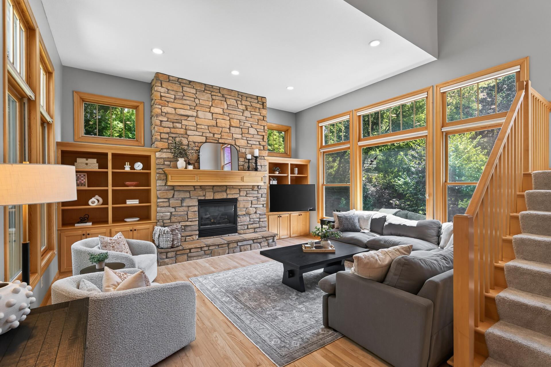 This living room is anchored by a stunning custom gas fireplace with stone surround and flanked by beautiful built-ins that make the space as functional as it is breathtaking.