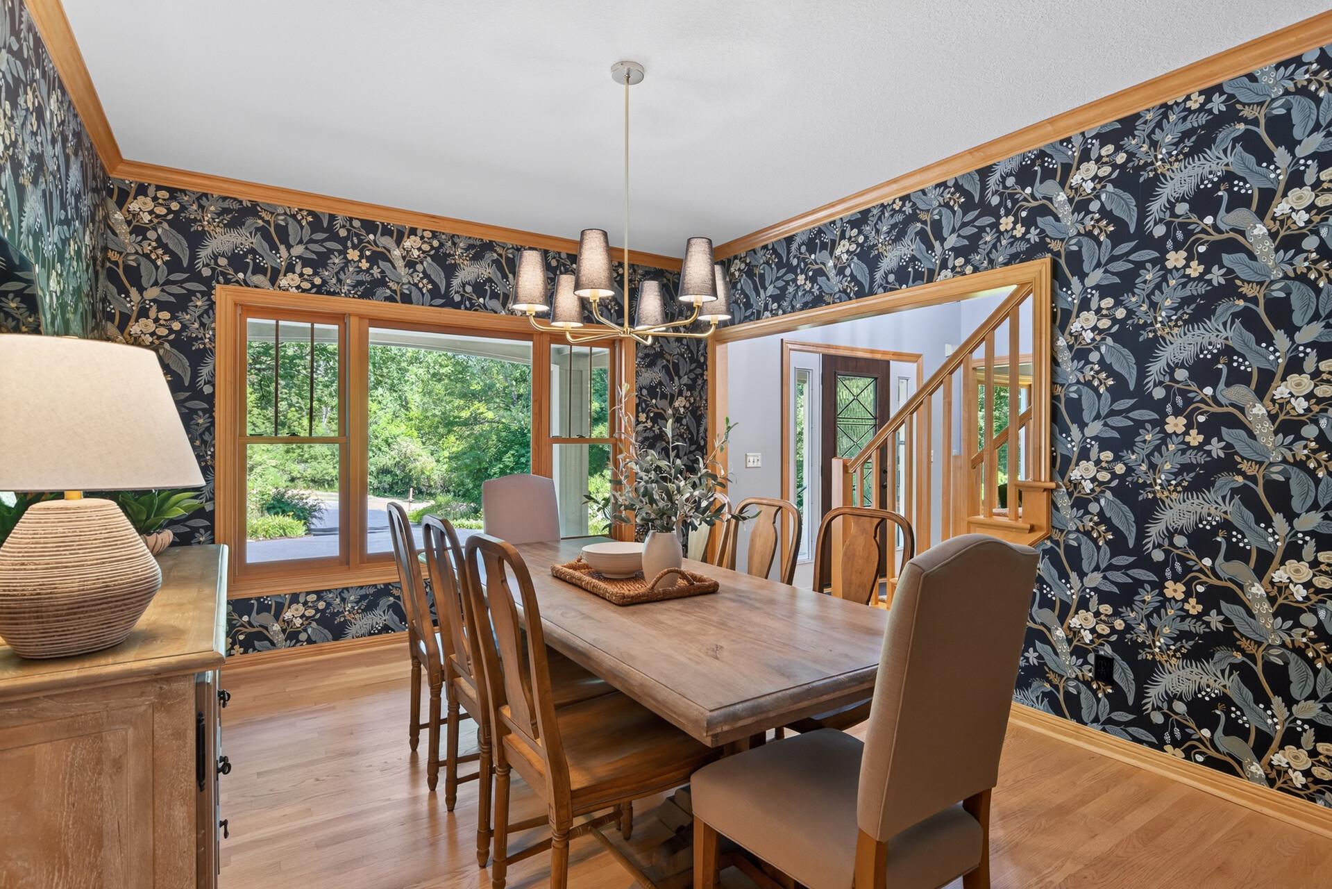 Designer perfection; this formal dining space is elevated by custom wallpaper that transforms the room into a work of art and sets the stage for unforgettable dinner gatherings.