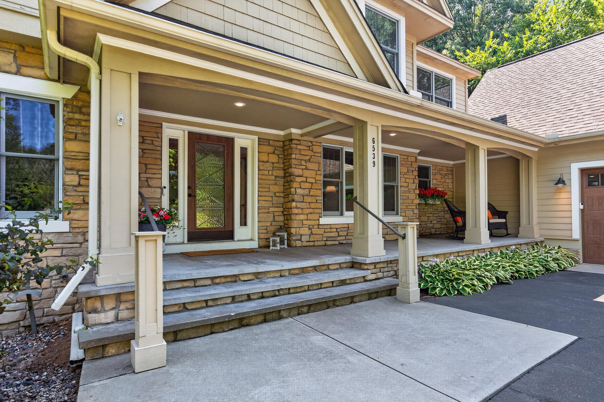 A grand front porch with plenty of seating is the kind of welcome most homes simply cannot offer; warm, inviting, and a perfect preview of the exceptional home that lies beyond the front door.