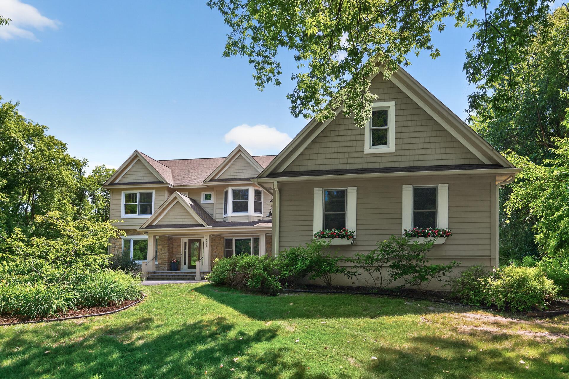 Another stunning angle of this magnificent craftsman-style exterior; and don't miss the charming window boxes just waiting to be filled with your favorite blooms and made completely your own.