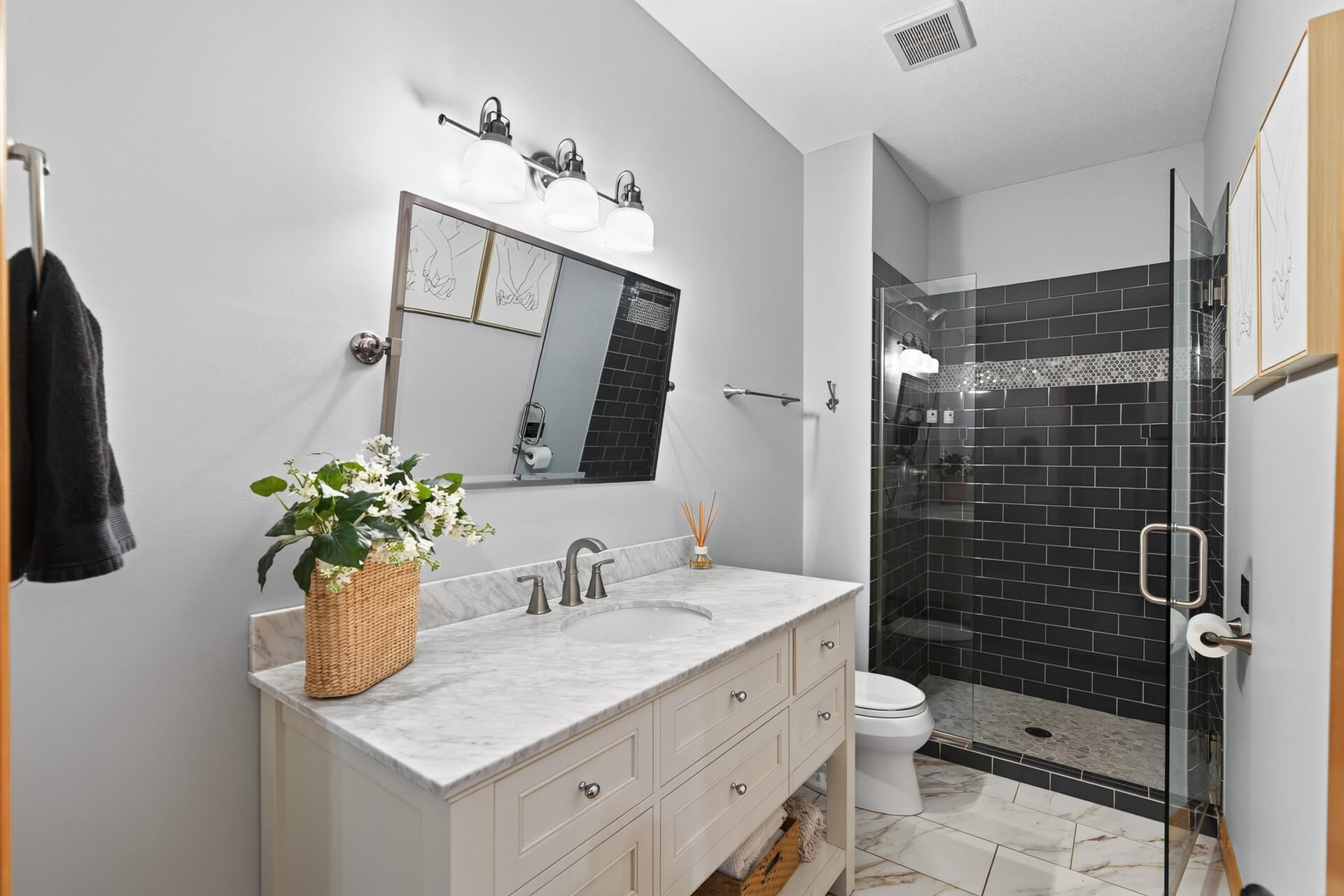 Your guests will feel like royalty in this stunningly designed Studio M custom bathroom, because in a home of this caliber, even the guest bath gets the luxury treatment.