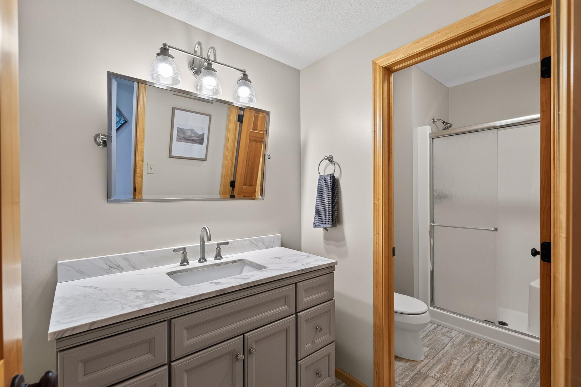 A full bathroom on the lower level is perfectly positioned for the swimming crowd; rinse off, change up, and get back to the fun without ever tracking through the main level of the home.