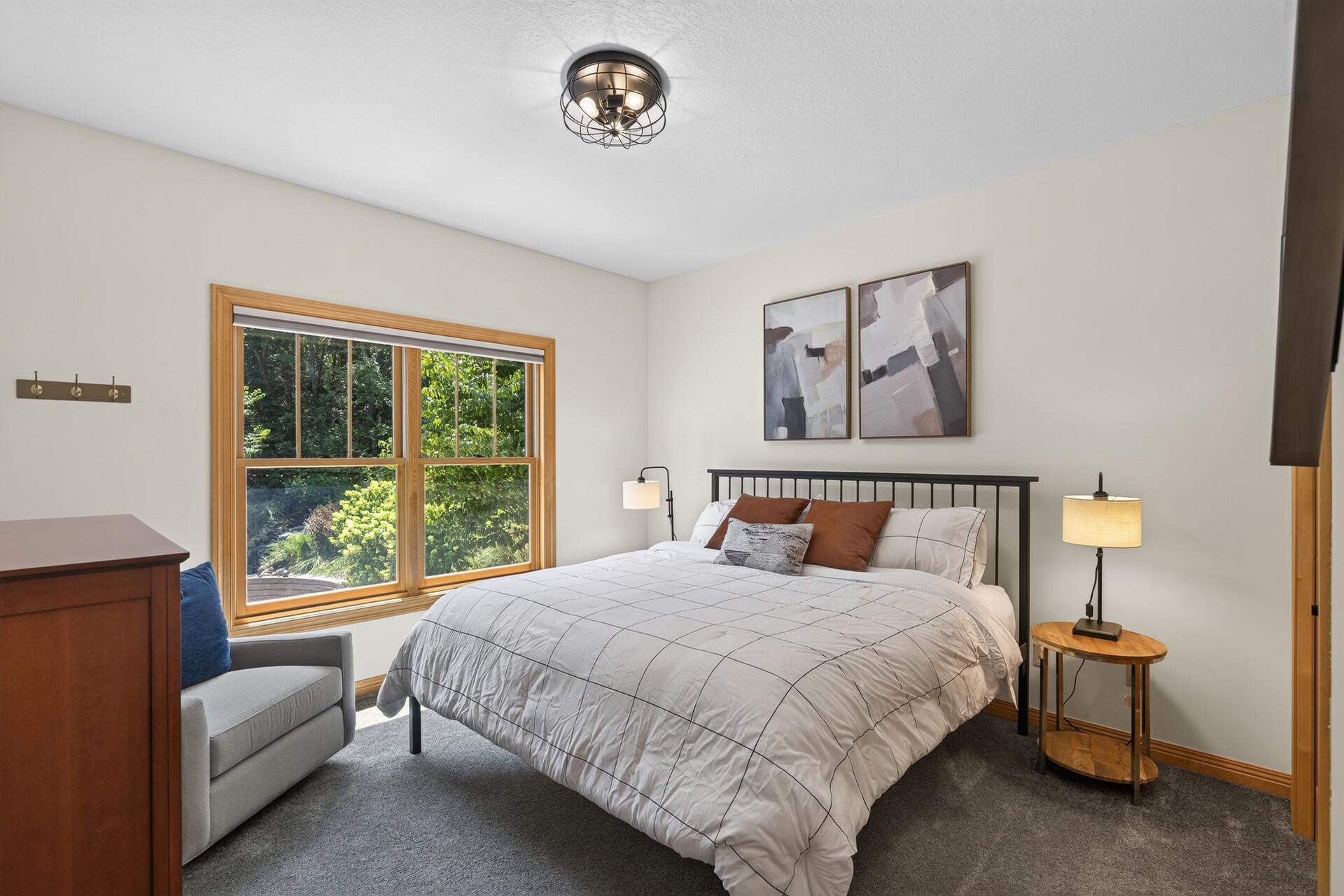 This thoughtfully positioned main-level bedroom is perfect for a live-in parent, a nanny suite, or any guest who deserves their own private space; complete with a convenient three-quarter bathroom just around the corner.