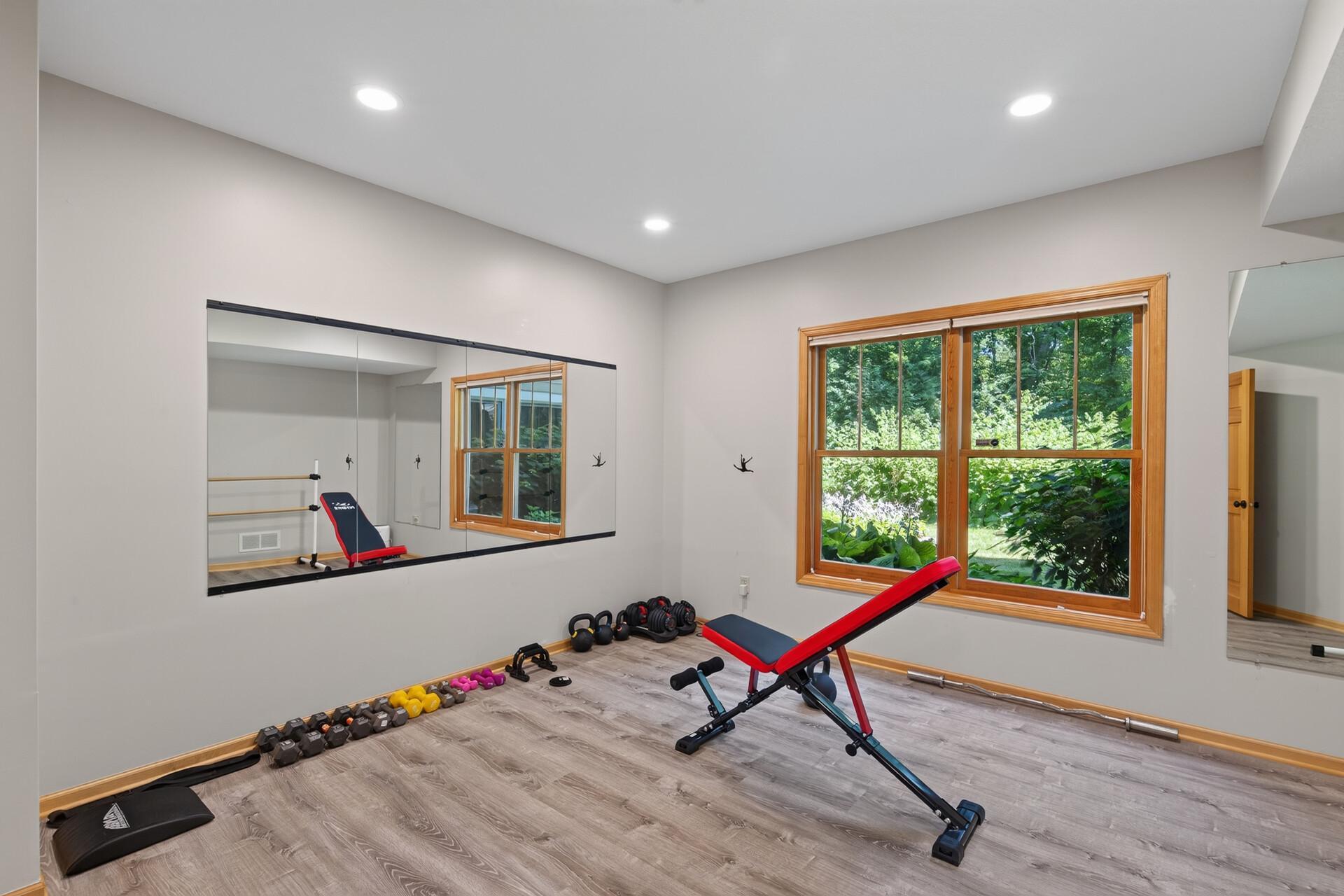 Whether it is your private dance studio, a dedicated exercise room, or both, this incredible lower-level space has the room, the light, and the energy to fuel whatever moves you. Notice the large windows in this home!