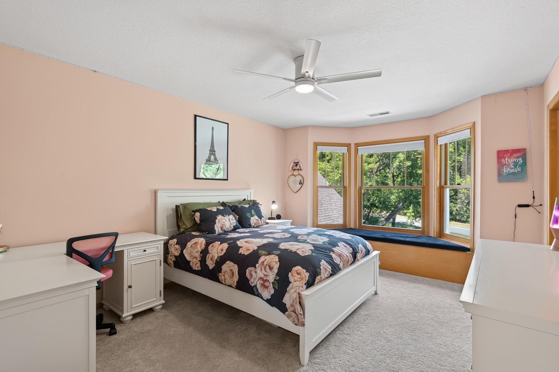Four bedrooms all on one level; and this third one does not disappoint, featuring a built-in bench that adds both charm and everyday practicality to a generously sized space.