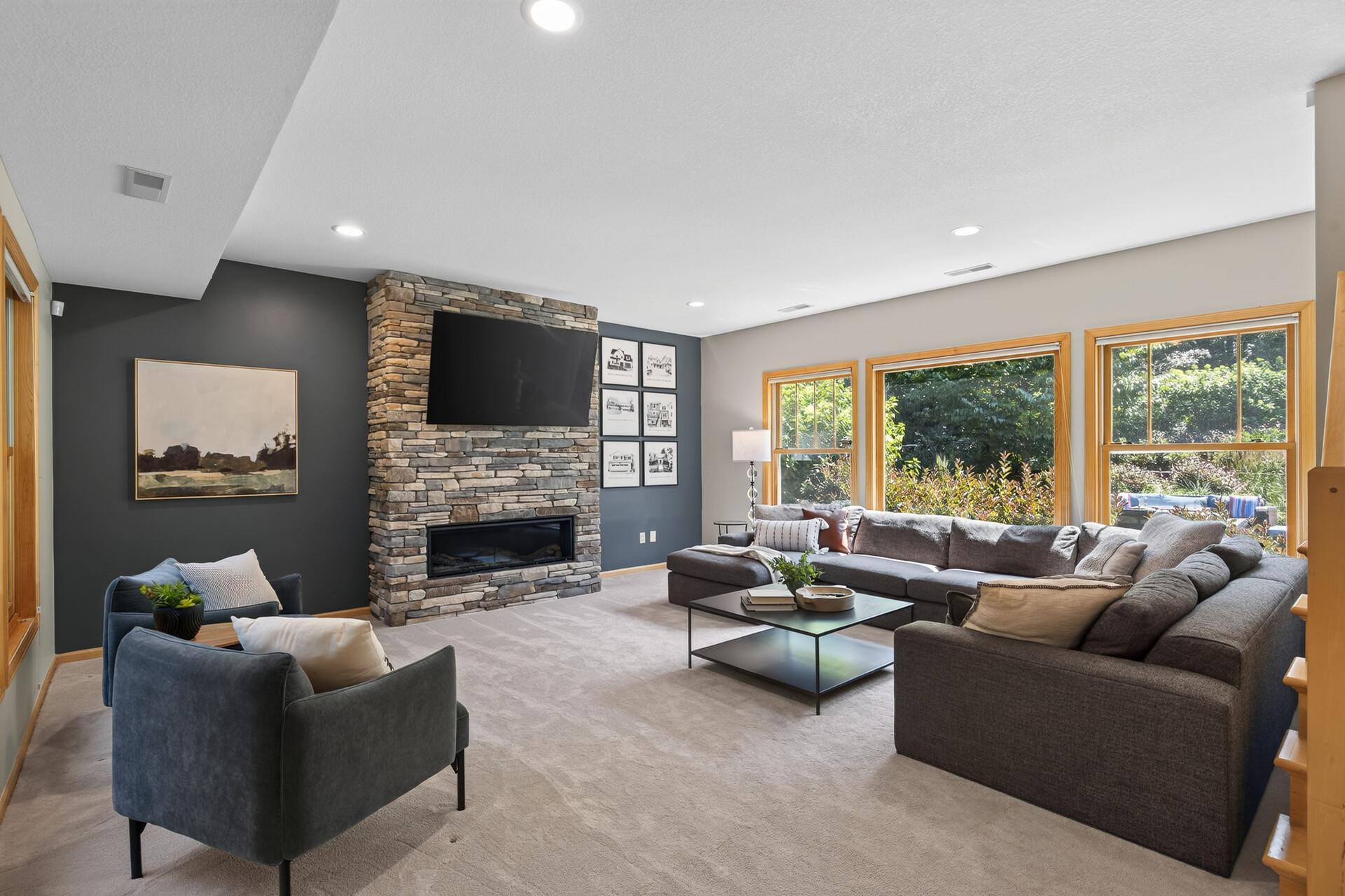 Movie nights, game days, holiday gatherings; this stunning lower-level family room with soaring ceilings, abundant natural light, and a beautiful gas fireplace is ready for every occasion and every memory your family will make here.