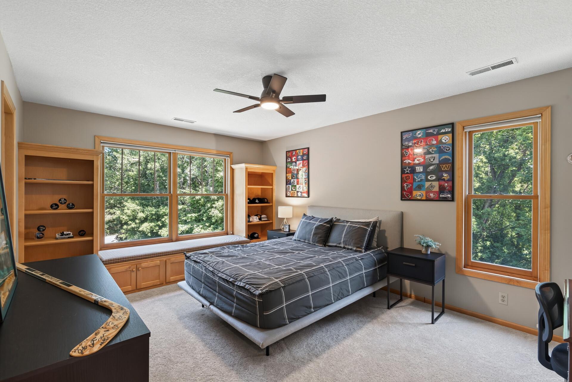 Second upper-level bedroom features custom built-in shelving and bench for extra storage and enjoy a great book.