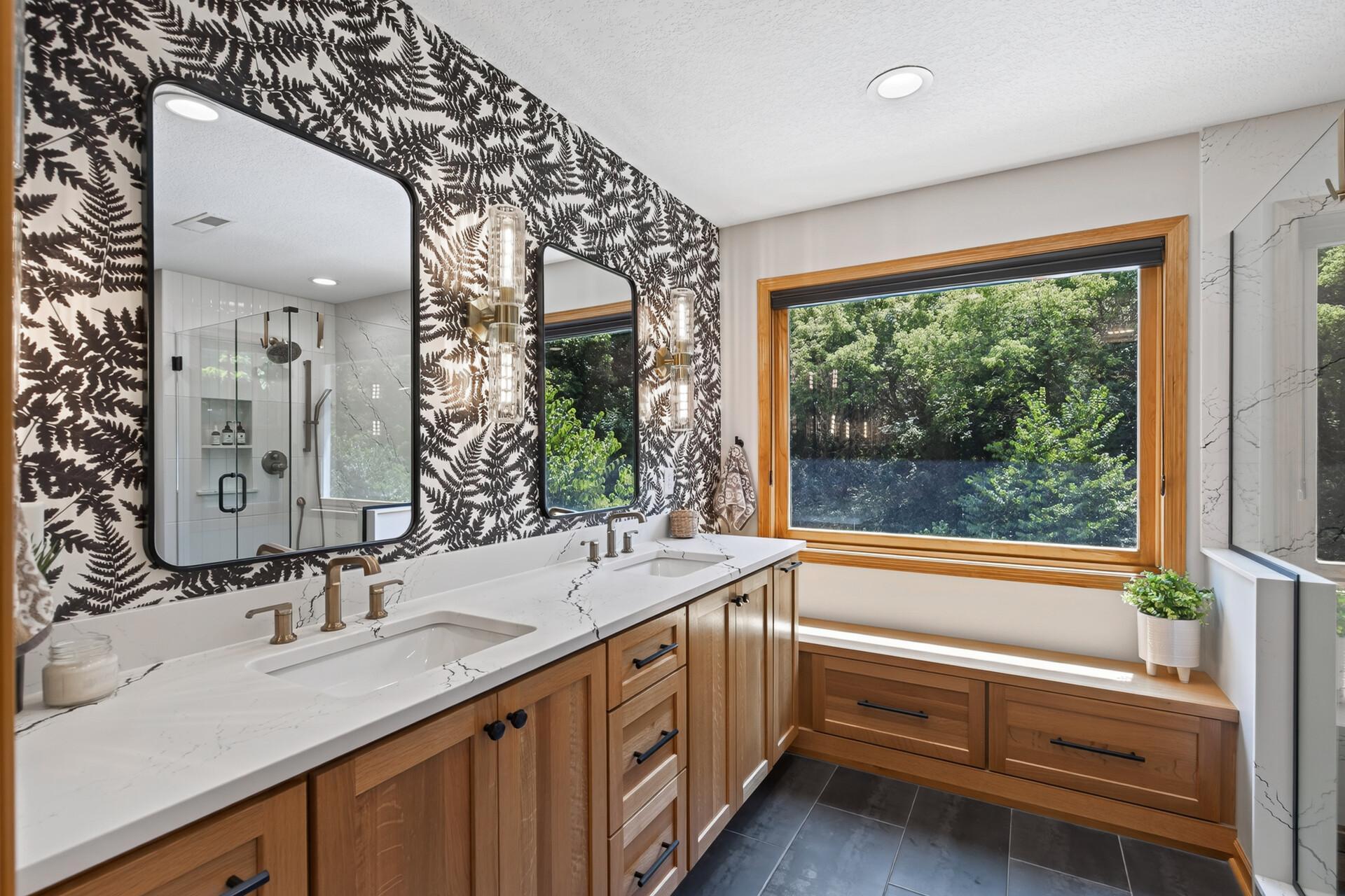 Every detail of this custom primary bathroom was chosen with intention; dual sinks, bench with storage, custom wallpaper, and designer finishes throughout that transform a daily routine into an executive-level luxury experience.