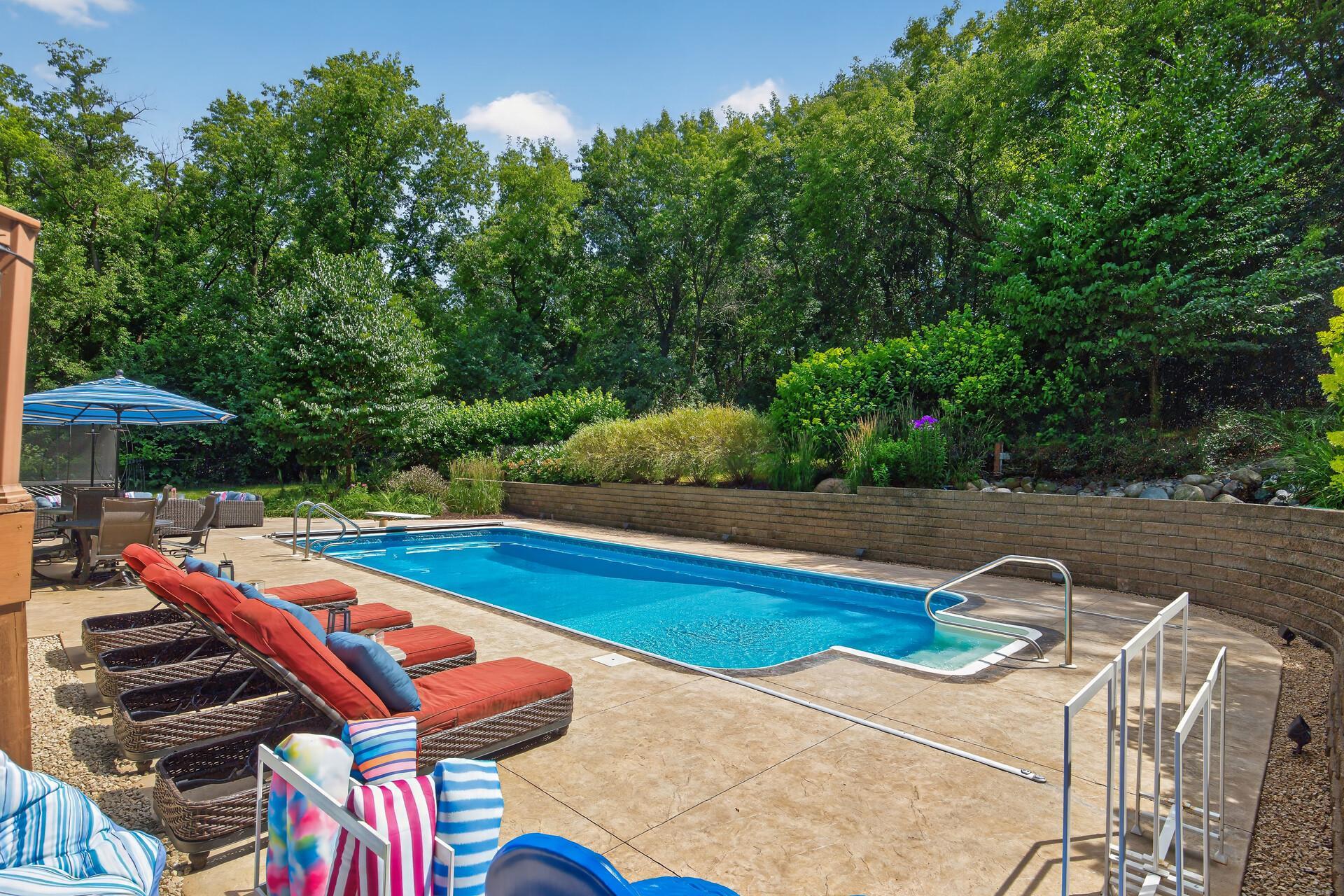 This is the backyard that makes the neighbors talk; a heated in-ground pool wrapped in stunning stained stamped concrete with generous lounge areas and entertaining space that rival any five-star resort.