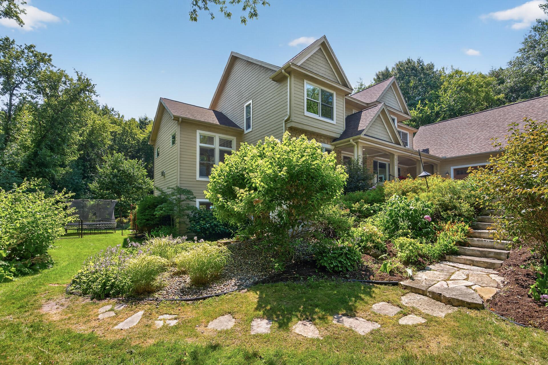 Thoughtfully designed landscaping offers natural stone steps to welcome you to the backyard resort oasis.