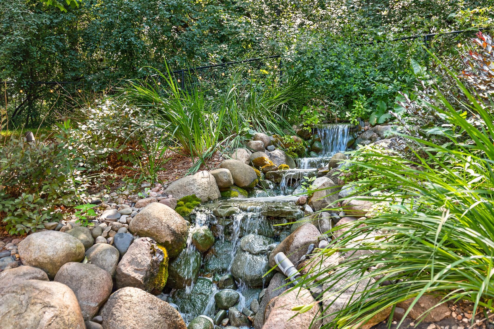 The sound of flowing water, the privacy of 3 acres, the beauty of professionally designed landscaping; this waterfall feature is the finishing touch that makes this backyard feel less like a yard and more like a destination.