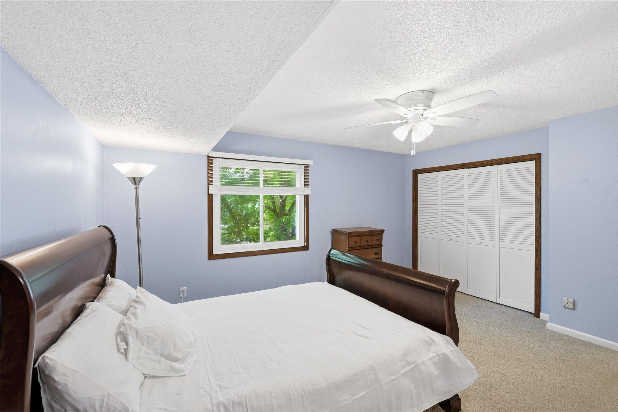 Upper-level primary bedroom with double door closet and walk-in closet