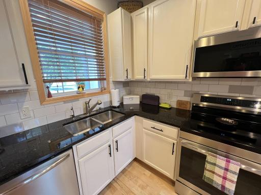 Kitchen window and ceramic tile back splash.