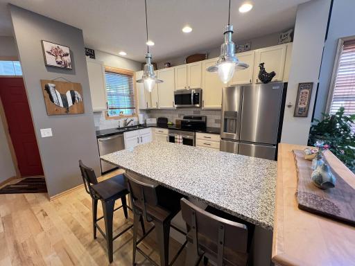 Spacious kitchen with new stainless steel appliances, added granite center island and re-finished cabinets.