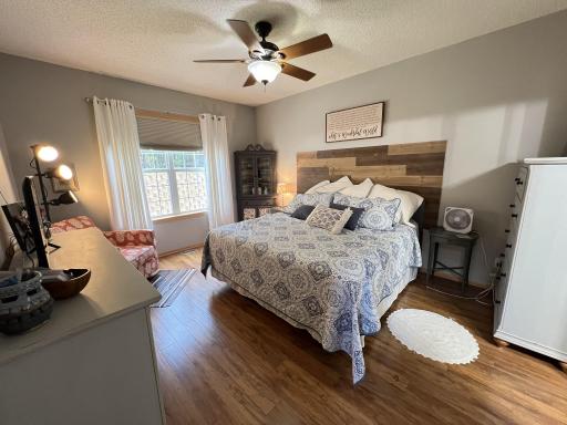 Main floor primary bedroom with newer engineered flooring.
