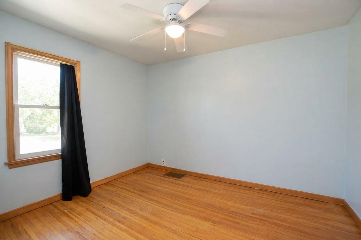 2nd mainfloor bedroom with wood flooring.