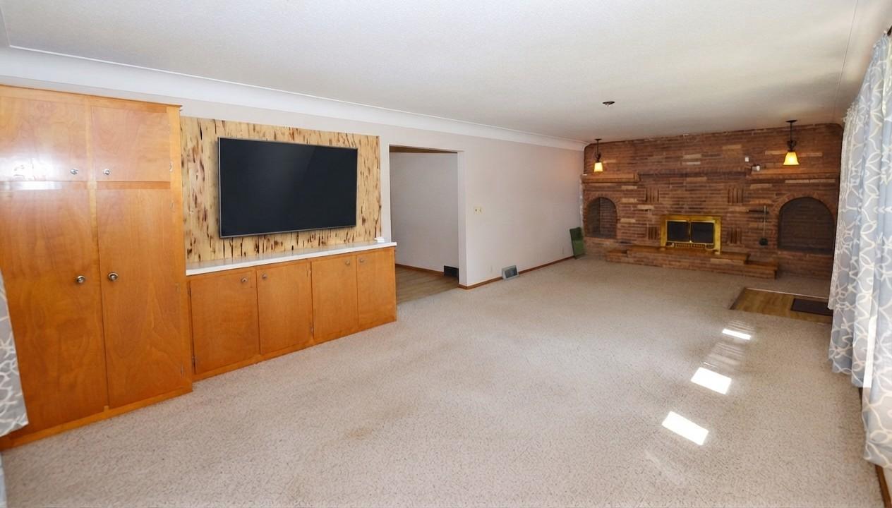 There are so many options here. Set up a dining area with the buffet & a cozy sitting area in front of the fireplace.