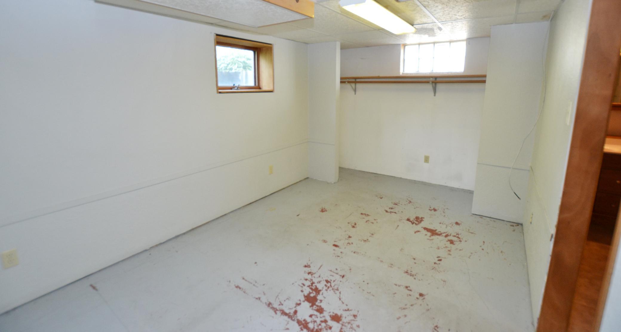 Lower level bedroom, easily add carpet to your liking.