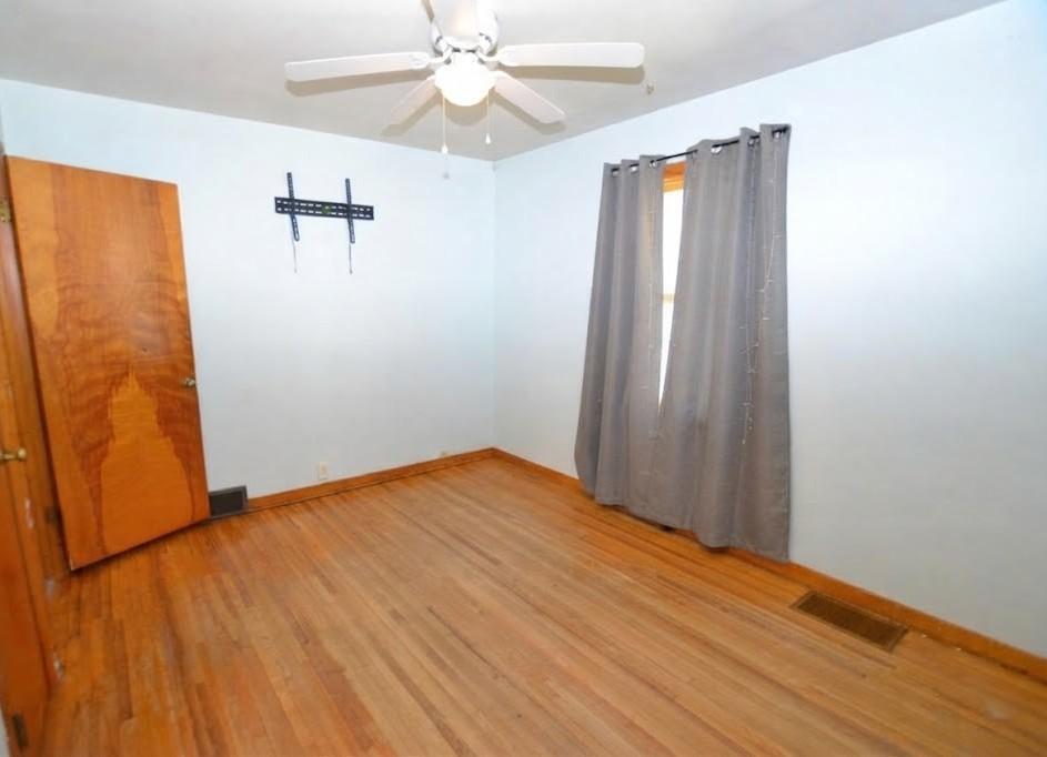 Mainfloor bedroom with wood floors.