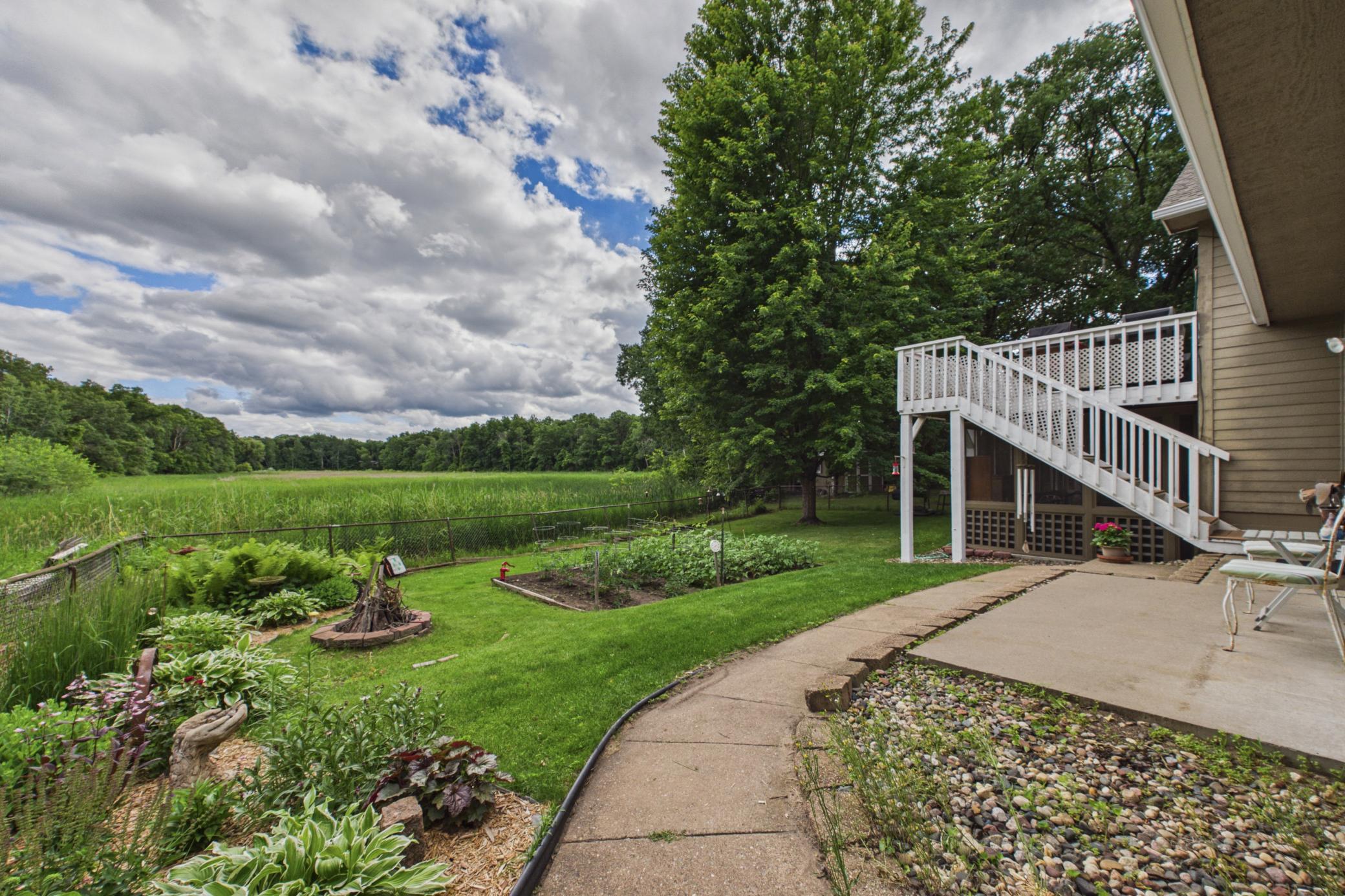 Fully fenced backyard living area overlooking peaceful pond setting