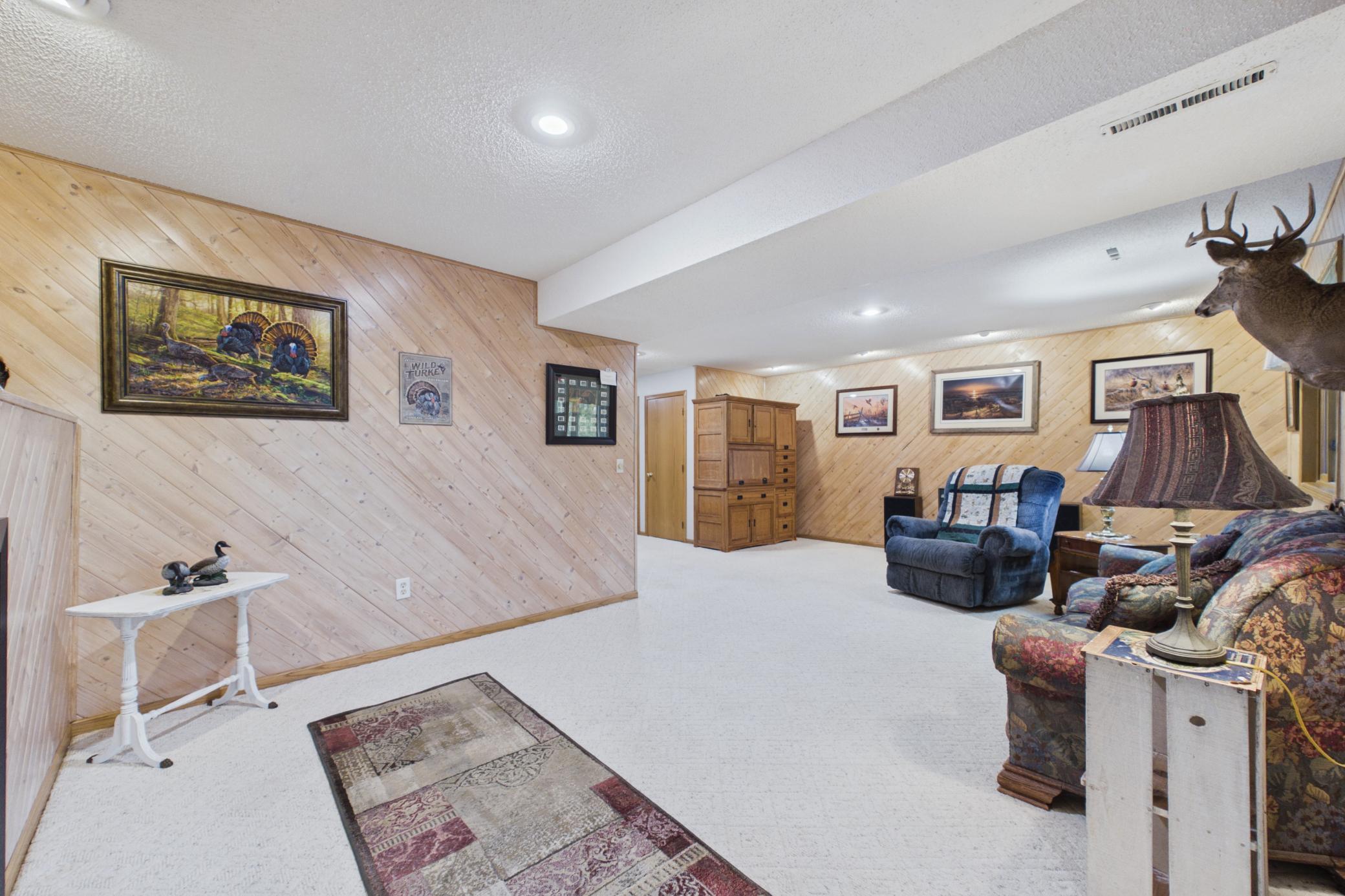 Cozy relaxation on lower level in this flexible family room area