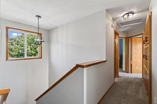 Hallway feels larger with the open staircase.