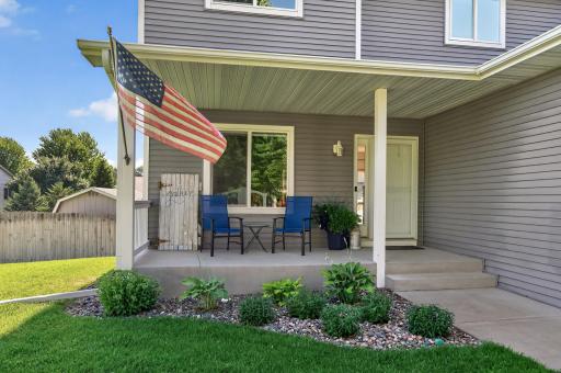 Nicely done landscaping frames the front porch.