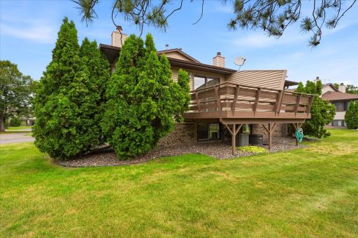 Side view of this unit with large deck & lots of green space.