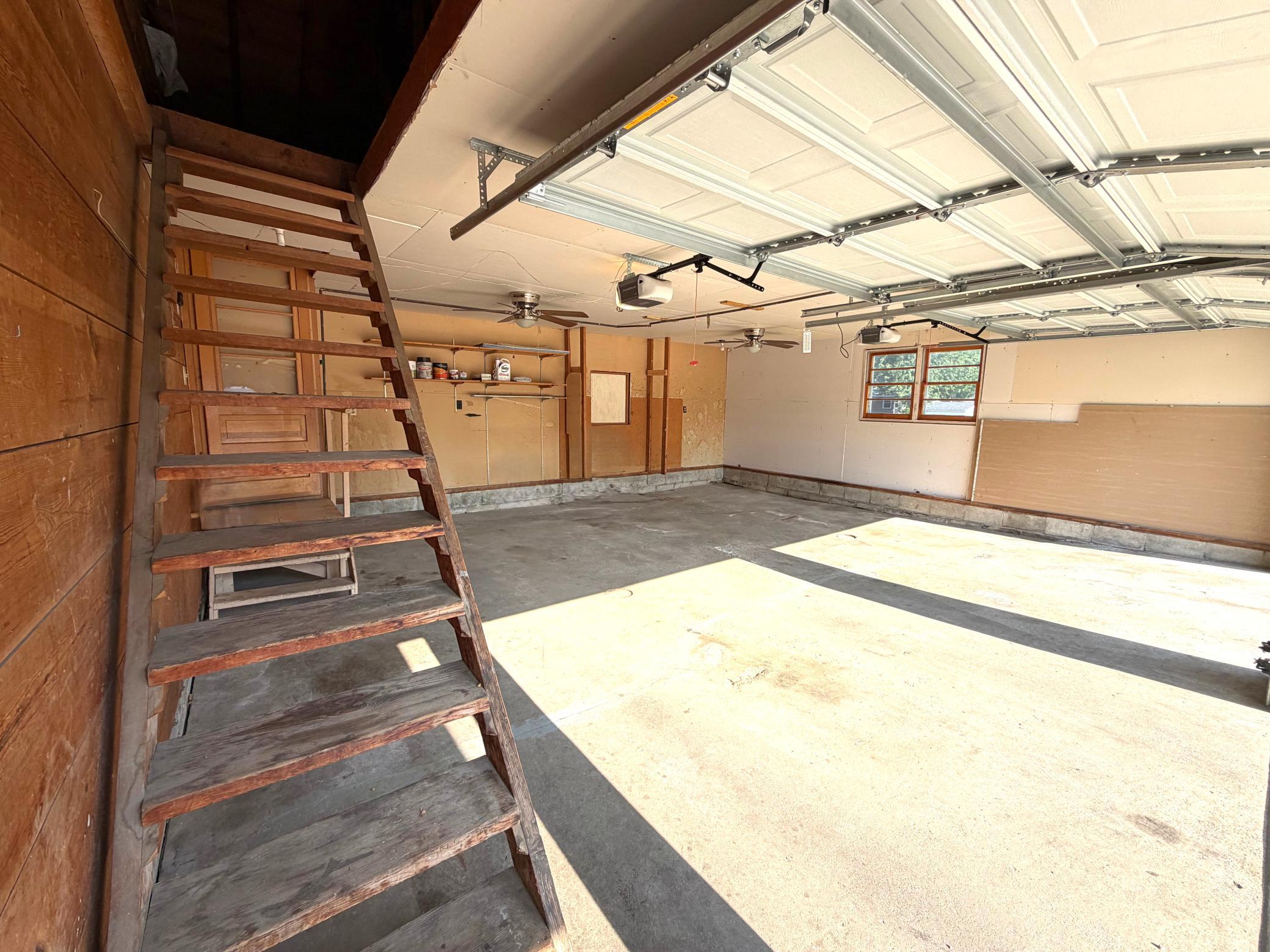 Garage with steps to attic