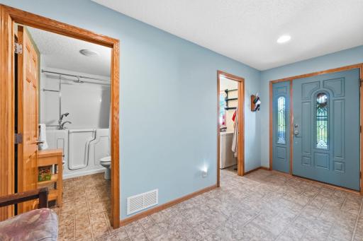 Spacious entry with room for a bench and hooks. The large coat closet is around the corner. Laundry and guest bath are located here.