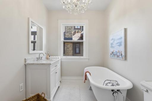 Additional second-floor full bath featuring a relaxing soaking tub.