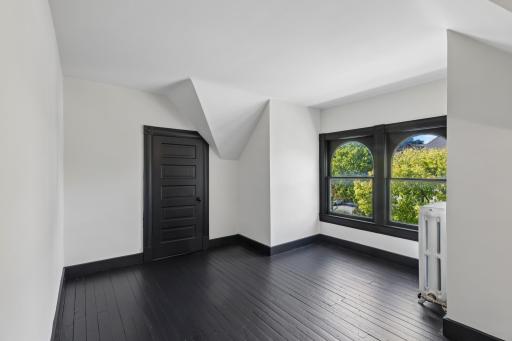Spacious third-floor bedroom offering a private retreat with plenty of room to relax.