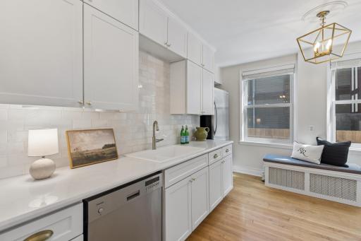 Bright kitchen with white cabinetry and warm gold accents.