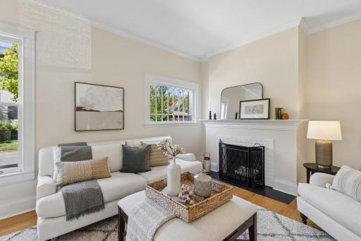 Spacious living room centered around a classic fireplace.