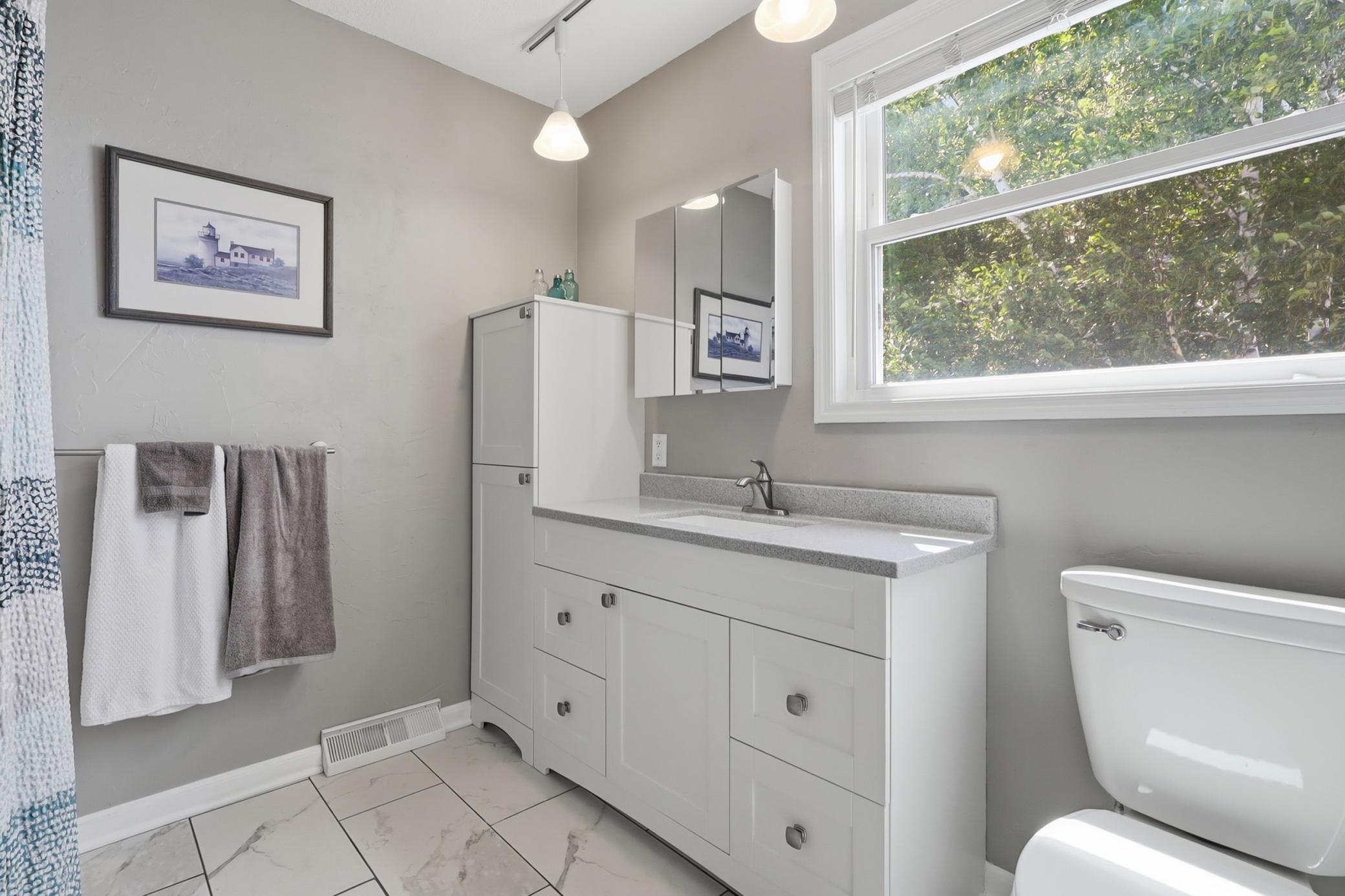 Upstairs Primary Suite Bath and yes big window that overlooks the lake!