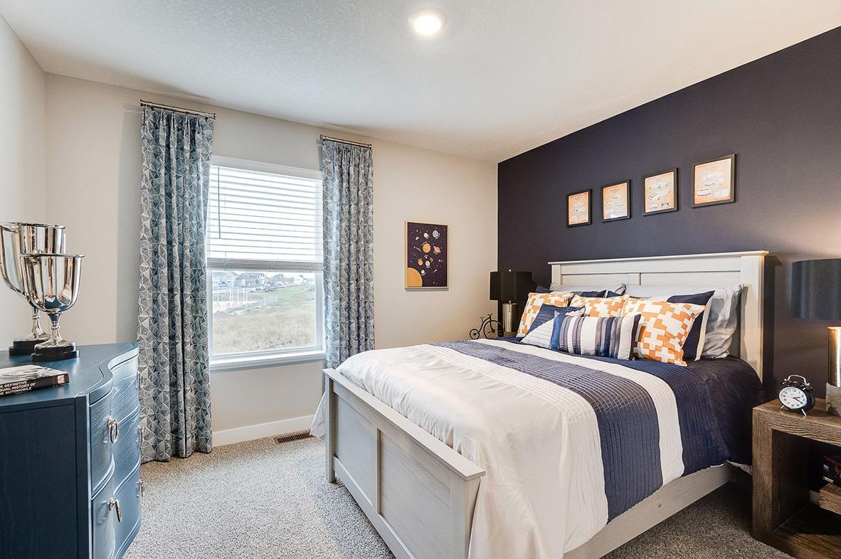 In addition to the primary bedroom, the home's upper level also includes these two additional bedrooms, and another full bathroom just adjacent to each! Photo of model, colors and options will vary. Ask Sales Agent for details.