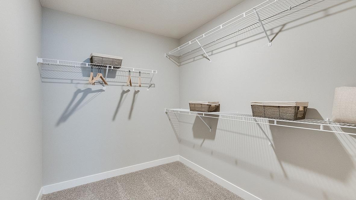Spacious primary bedroom walk-in closet! Photos of model home. Colors and options may vary. Ask Sales Agent for details.
