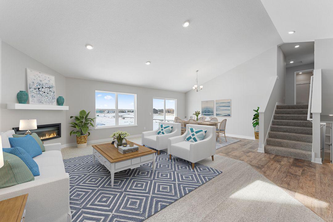 The home's main level living space is loaded with space, and can accommodate just about any family room furniture set-up. Photo of a virtually staged model, colors and options will vary. Ask Sales Agent for details.