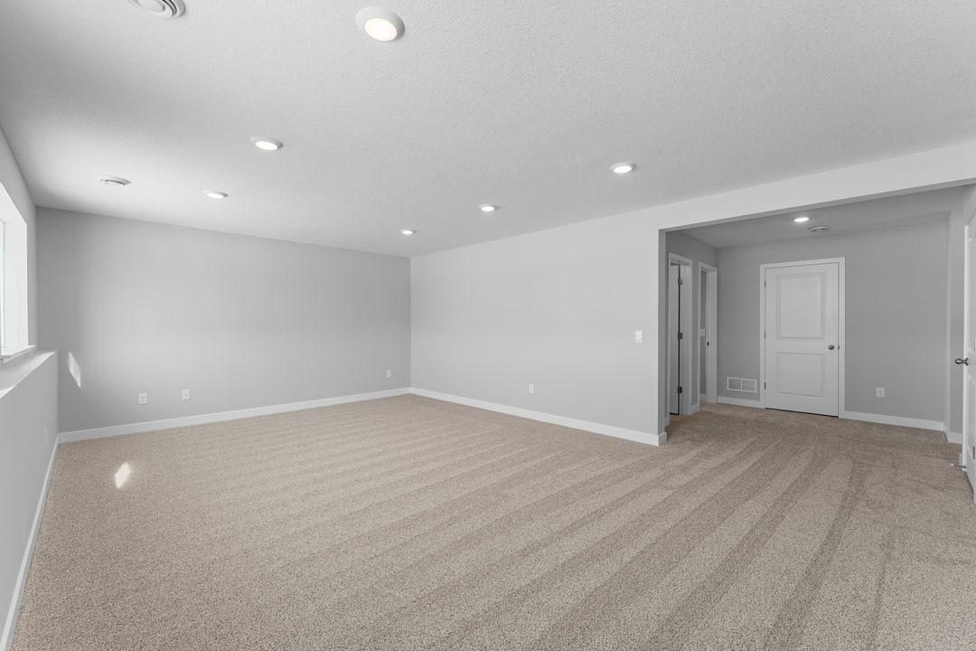 View of the lower level family room with the ability to walk-out into your rear yard! Photo is of a similar home. Colors and options may vary. Ask Sales Agent for details.
