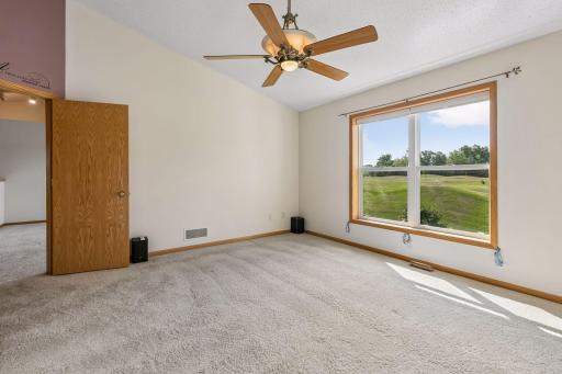 oversized main level primary bedroom with a perfect view