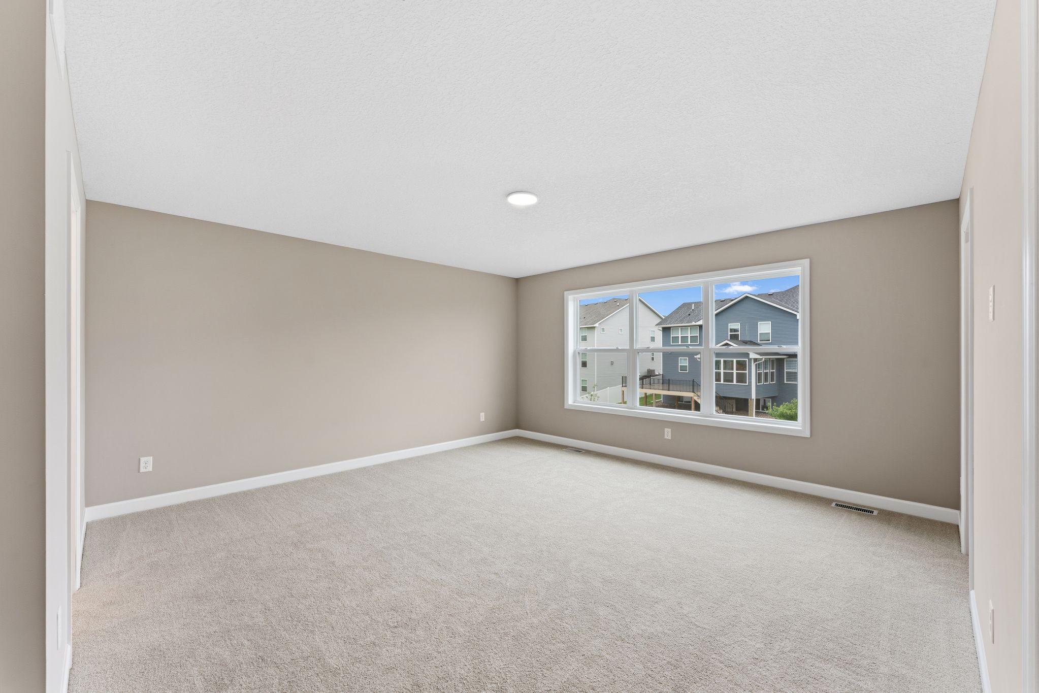 The expansive owner’s suite is located on the second level, complete with a restful bedroom, an en-suite bathroom and two walk-in closets.