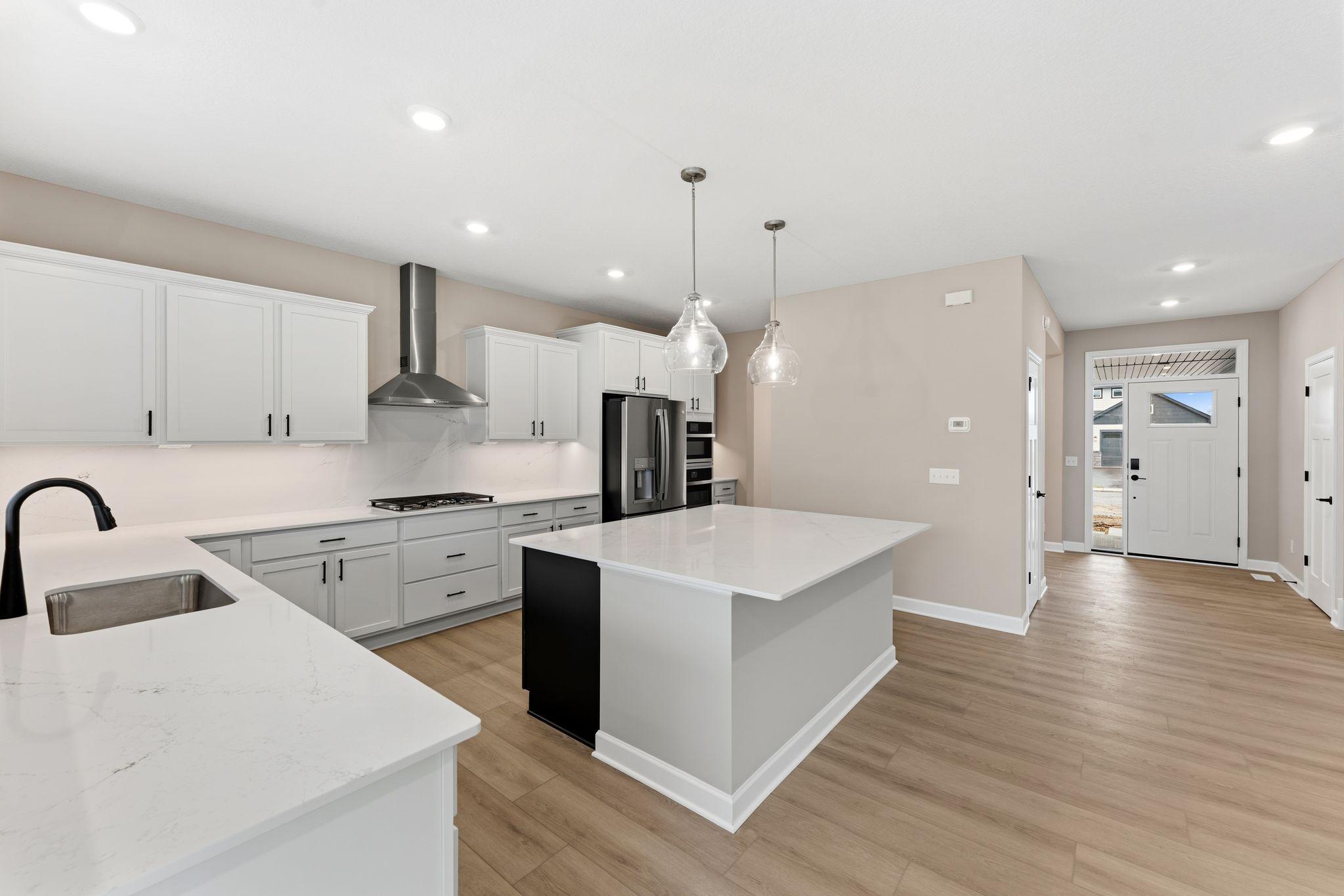 The center island extends out to a breakfast bar for casual meals