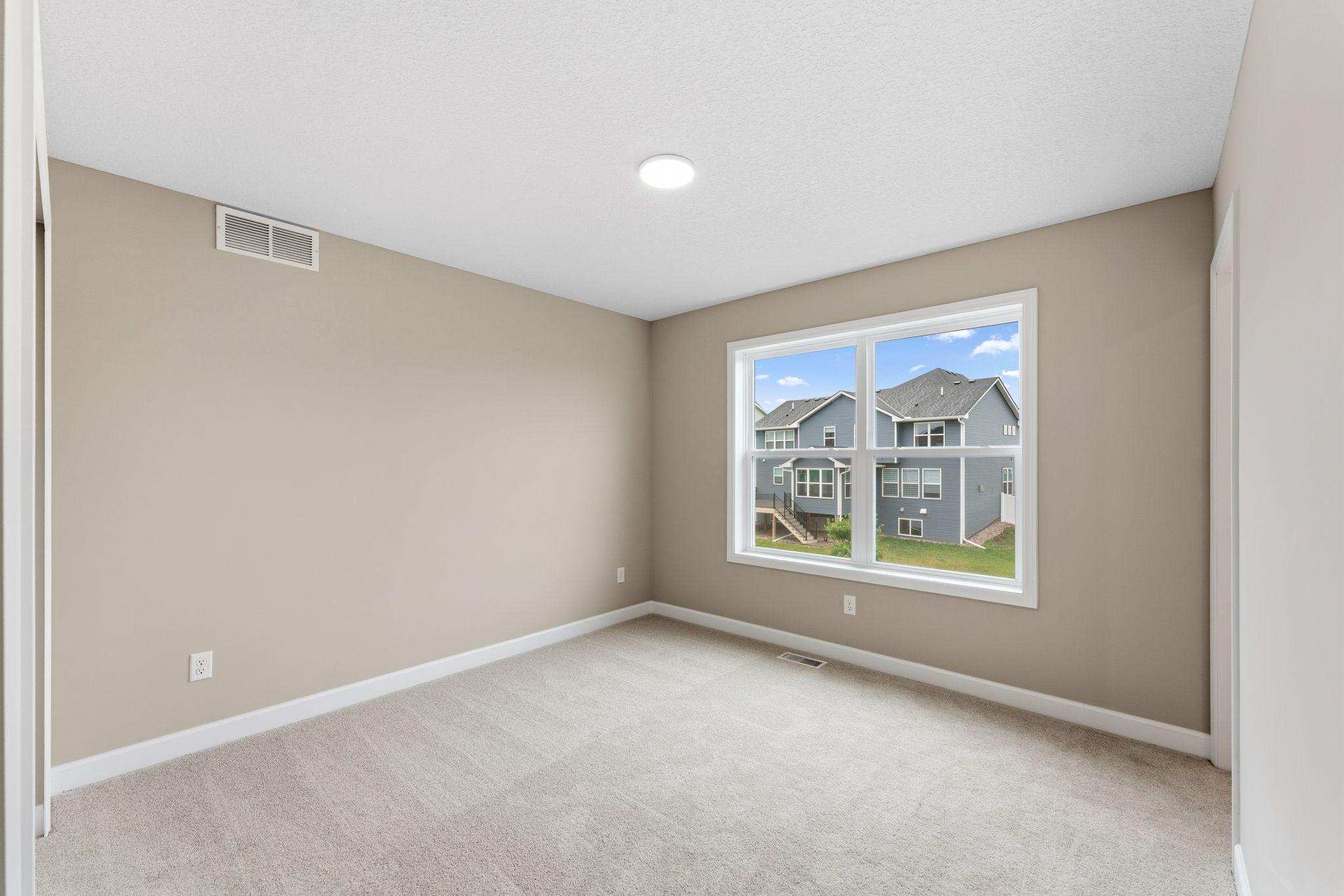 This secondary bedroom features an en-suite bathroom, making it a great space for overnight guests or household members that need more privacy.