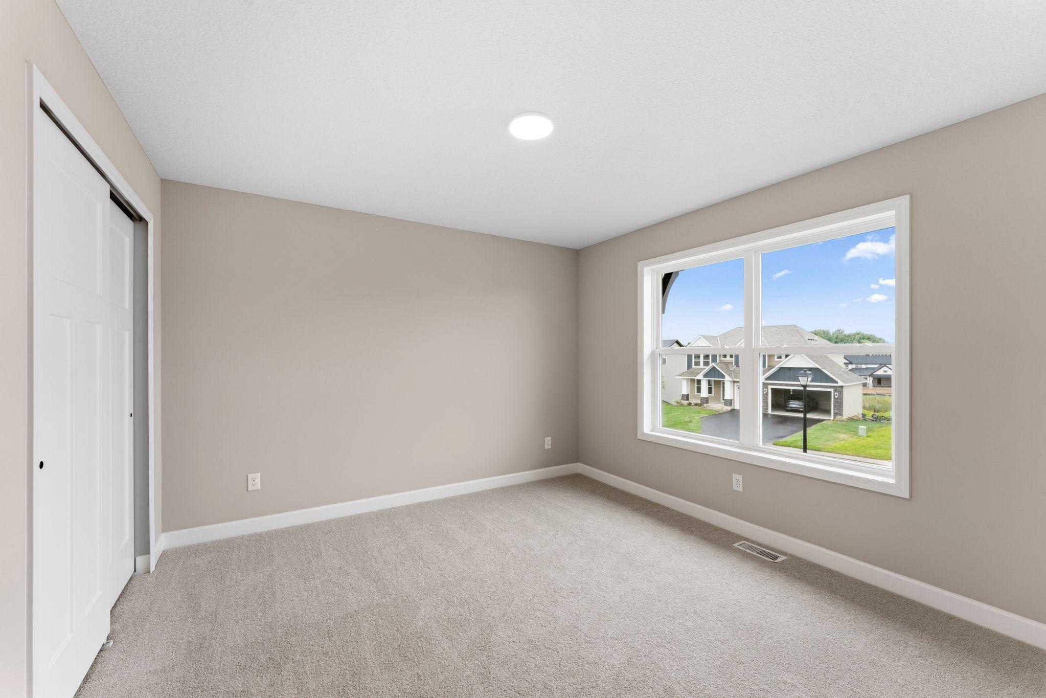 Three secondary bedrooms are located on the second floor.