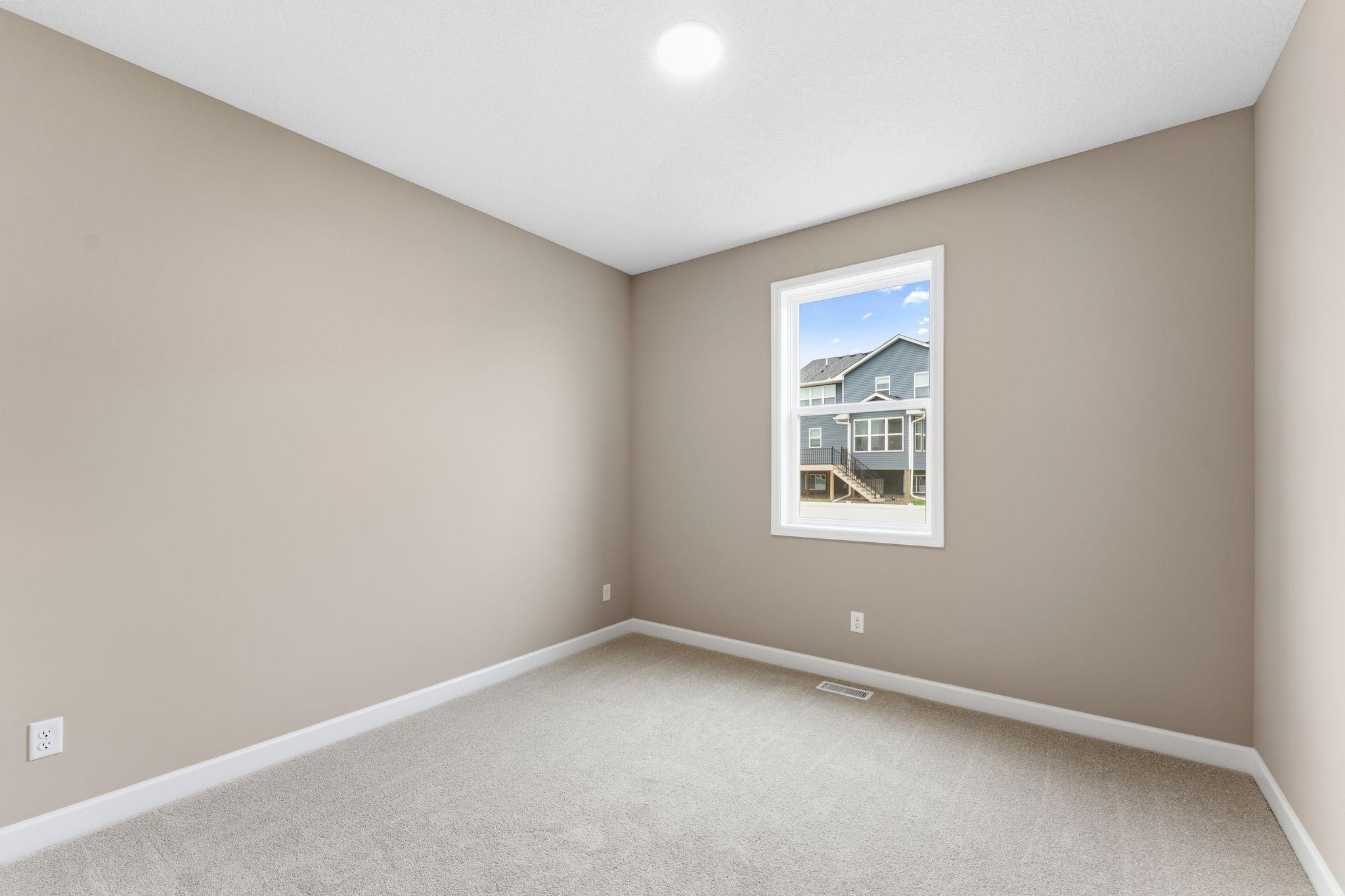This bedroom is sequestered from the rest of the first floor living spaces, creating a quiet environment ideal for overnight guests or remote work.